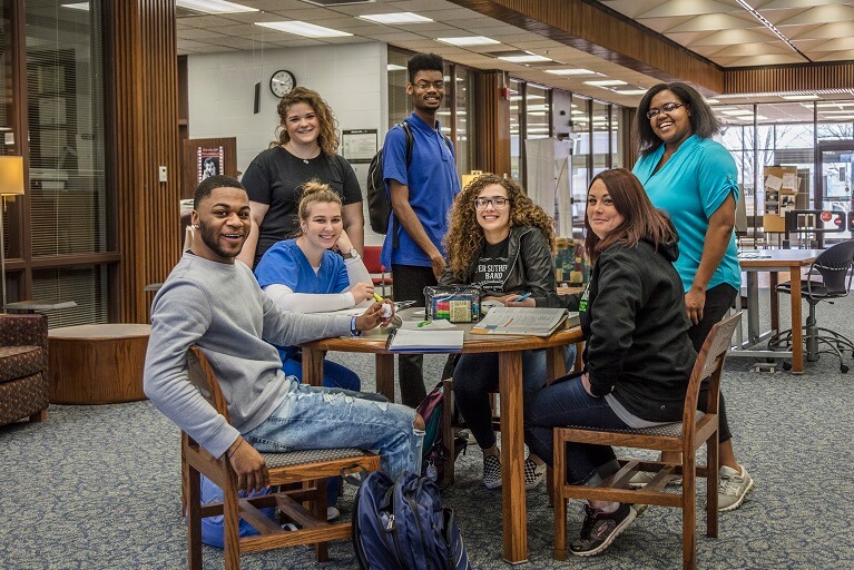 group of students posing in a library